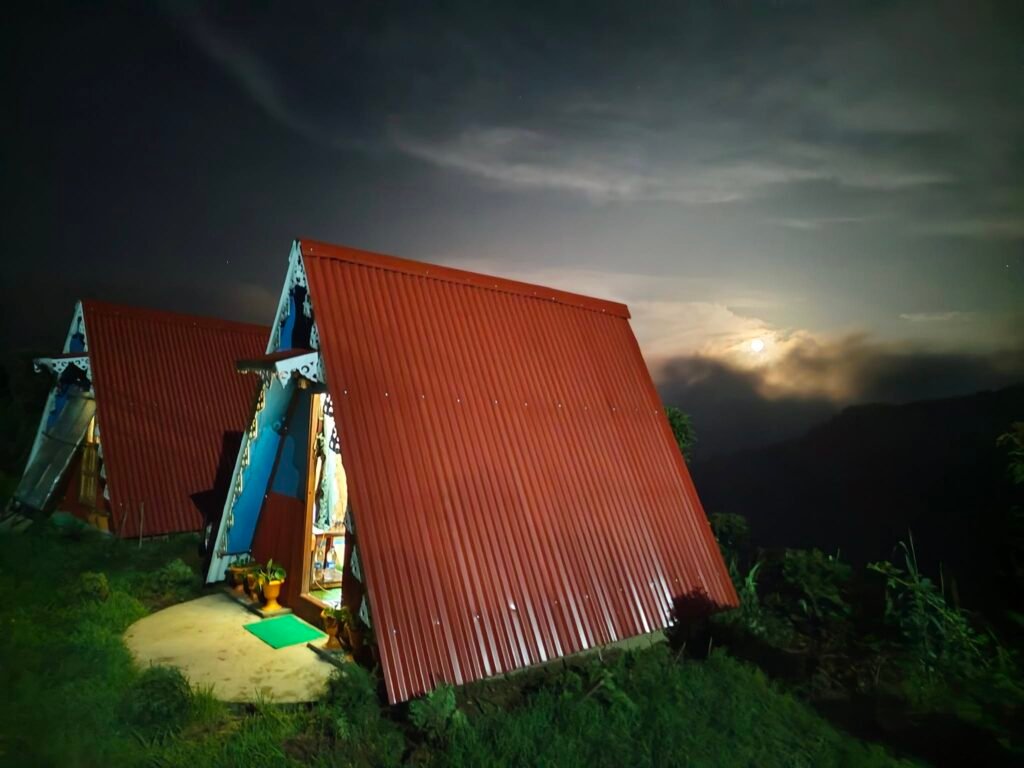 Wooden A-frame cabin at dusk
