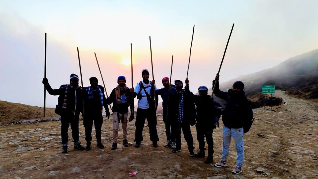 Trekkers with poles at sunrise
